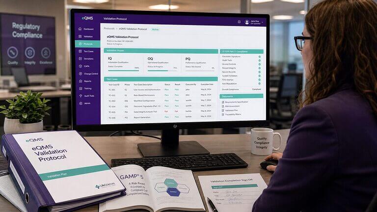 CSV specialist reviewing eQMS validation protocol with IQ OQ PQ test records and GAMP 5 reference guide on a regulated compliance workstation